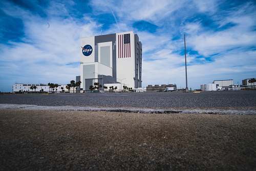 kennedy space center visitor complex landscape photography of white buildings near road during daytime titusville